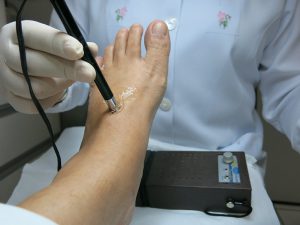 A doctor examining a foot