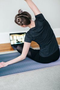 Young woman doing an online yoga class