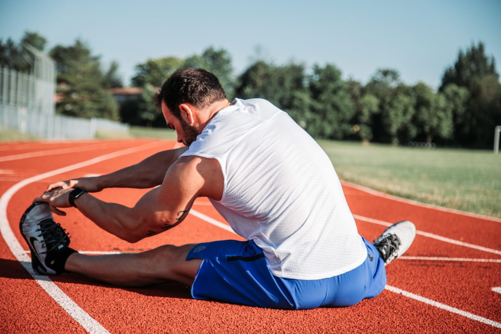 Person holding foot and stretching prior to exercise